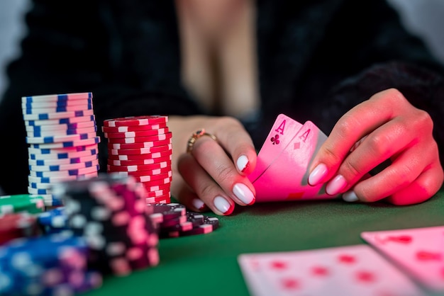 Girl in the poker game has won everything and takes all the chips with her hands