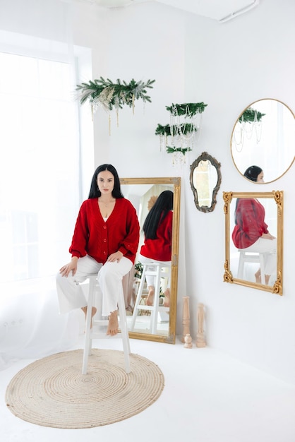 A girl posing against the new years eve background young girl in a red sweater