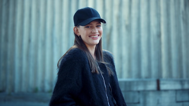 Girl posing at camera on urban street Closeup stylish woman laughing outside