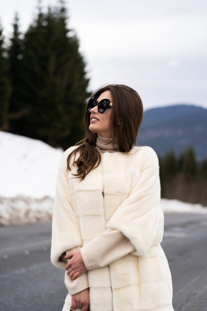 Girl posing on road on winter woods