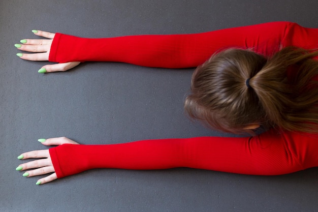 Girl practicing yoga at home Indoor and outdoor workout Sport and healthy active lifestyle concept Child pose top view