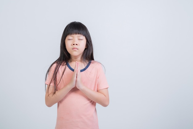 Girl praying on white background