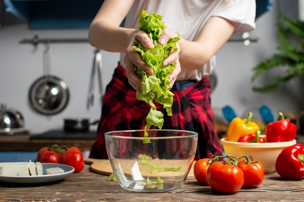 Girl prepares a vegetarian salad