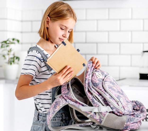 Girl preparing backpack