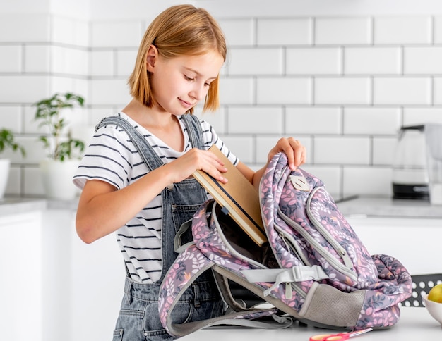 Girl preparing backpack