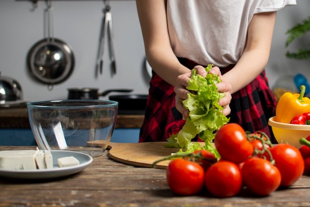 Girl preparing vegetarian salad