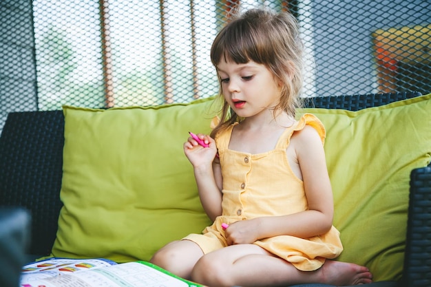 Girl preschooler studying at home