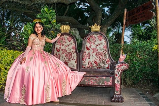 Girl in princess dress posing on a decorated wooden bench