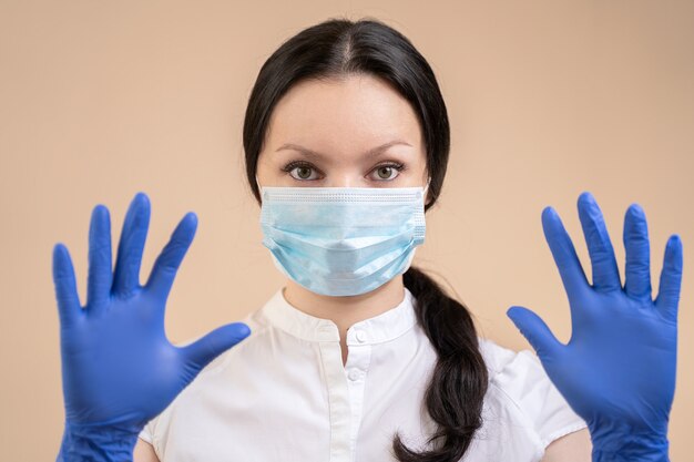 A girl in a protective mask and gloves