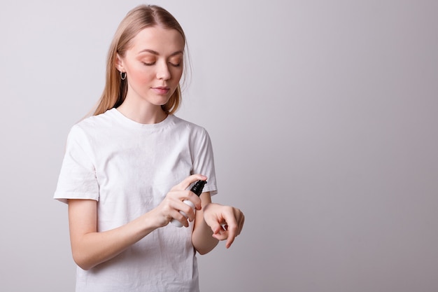 Girl puts cosmetic oil on her hands