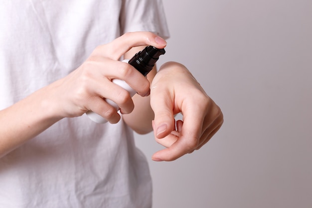 Girl puts cosmetic oil on her hands