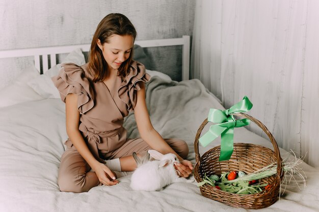 Girl and rabbits. Easter symbols, pets bunnies. High quality photo