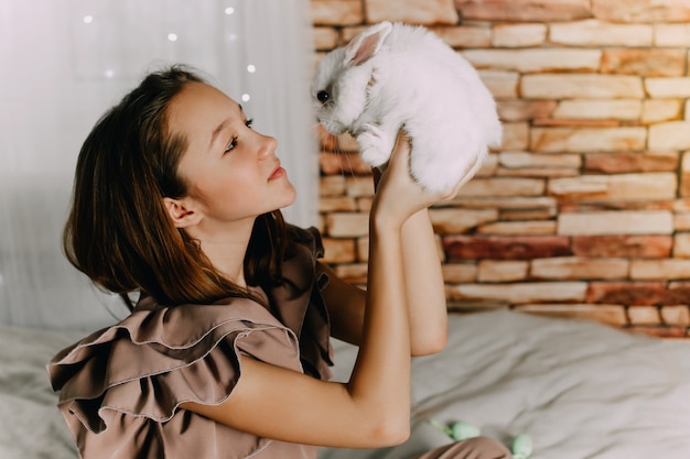 Girl and rabbits. Easter symbols, pets bunnies. High quality photo