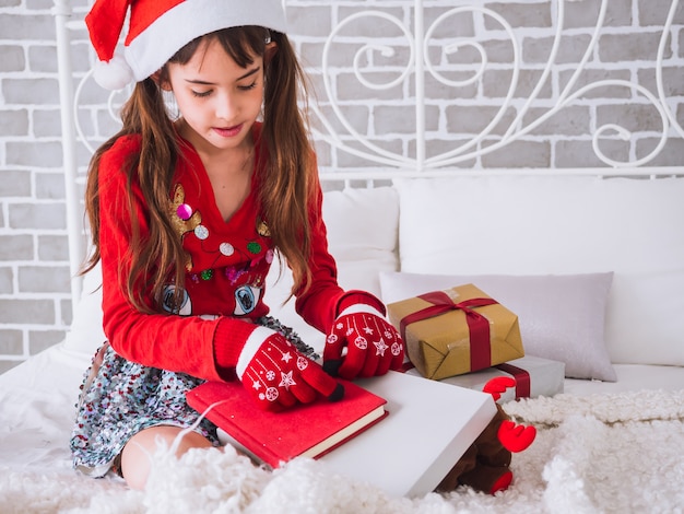 The girl received the red book as a gift on Christmas day