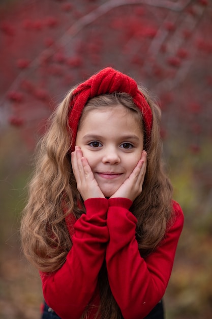 girl in red outfit in autumn forest