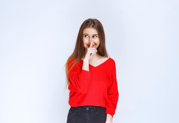 Girl in red shirt thinking and brainstorming. 