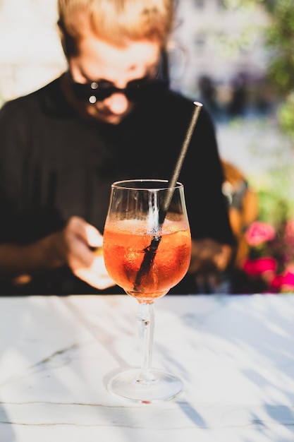 Girl relaxing in a cafe with a cocktail