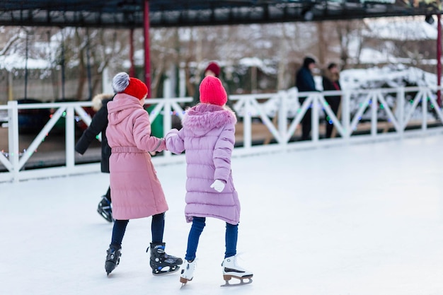 The girl rides on the rink in winter The girl on the rink Girl With Long Hair Skates On An Ice Rink In The Sunlight And Glare Sport And Hobbies