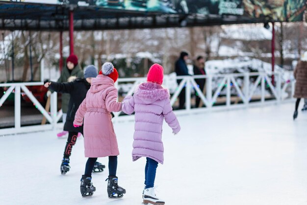 The girl rides on the rink in winter The girl on the rink Girl With Long Hair Skates On An Ice Rink In The Sunlight And Glare Sport And Hobbies