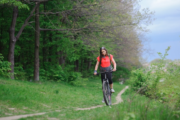 Girl riding a bike in the woods