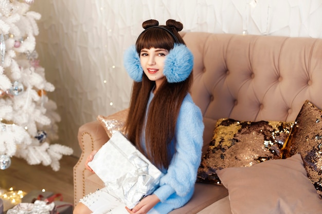 Girl in a room with Christmas tree and decorations