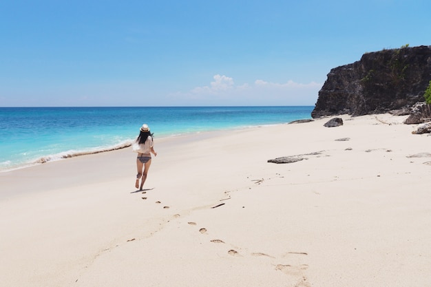 Girl runs along the sea in Bali