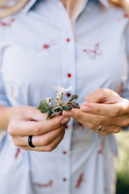 In the girl's hand a flower