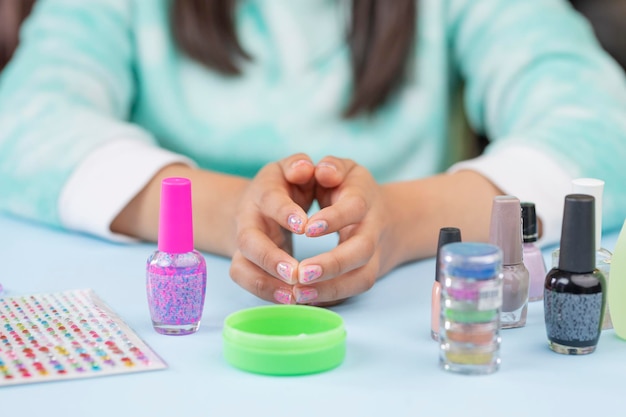 Girl's hands showing nails after painting them with copy space