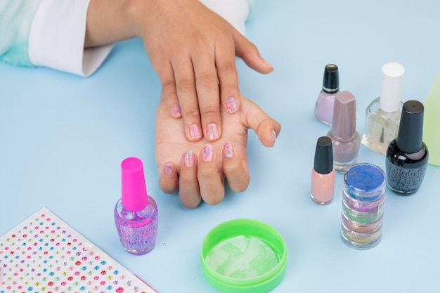 Girl's hands showing nails after painting them with copy space