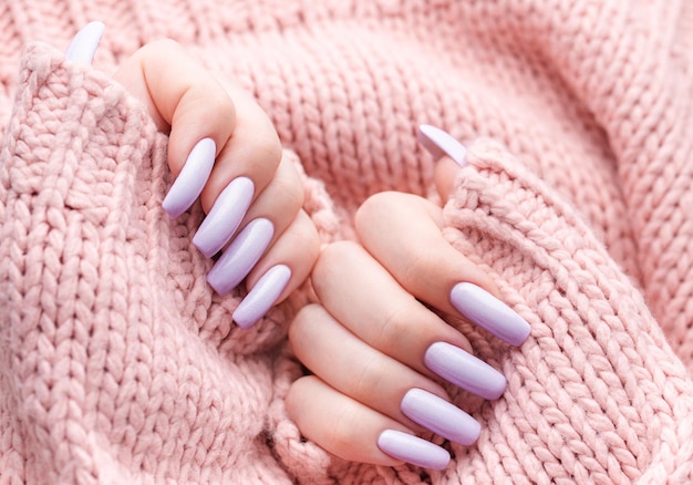 Girl's hands with a soft purple manicure