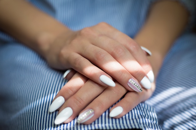 Girl's hands with wedding manicure 