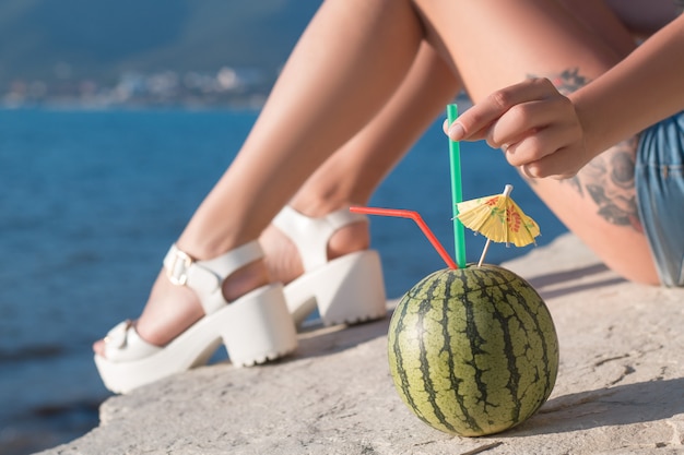 The girl of the sea with a cocktail of watermelon