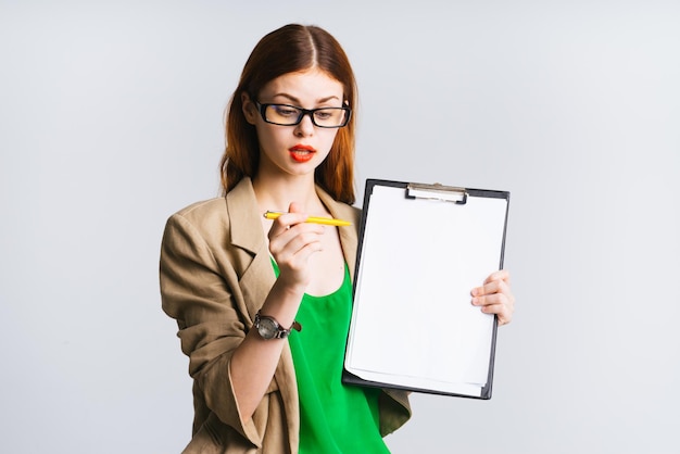 Girl secretary looking surprised at her pen holding a file in her hands