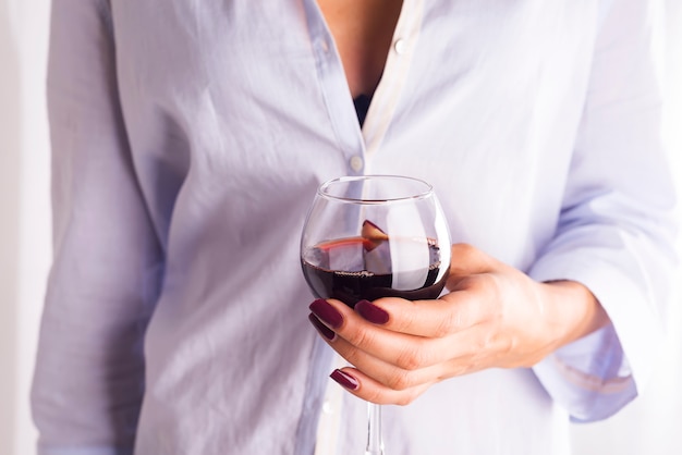 Girl in a shirt with a glass of red wine