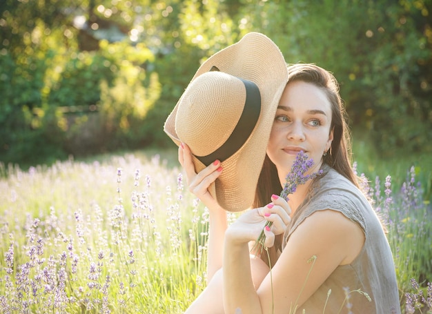 The girl sit in the middle of a lavender field