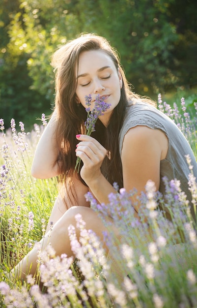 The girl sit in the middle of a lavender field