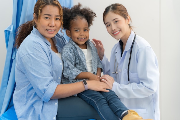 The girl sits on the patient's bed for the doctor