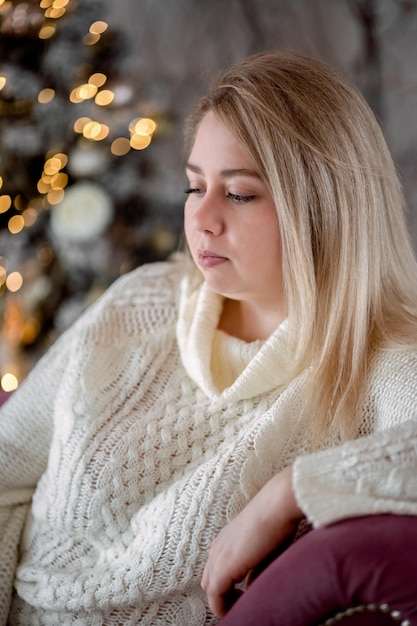 girl sitting by the christmas tree