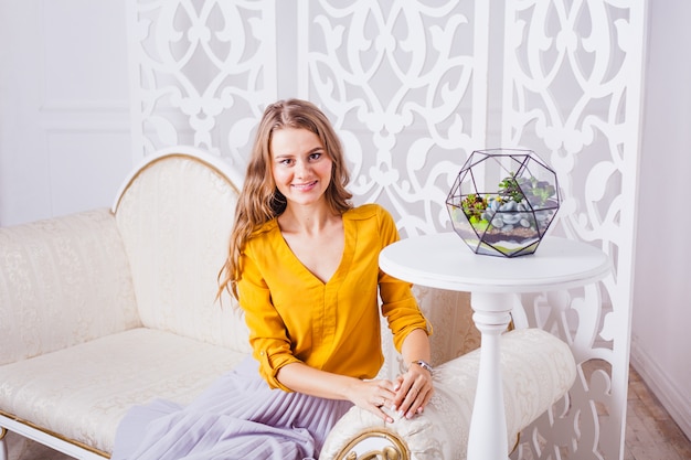 Girl sitting on a chair in the bright interior