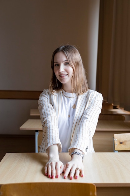 Girl sitting at the table in the classroom