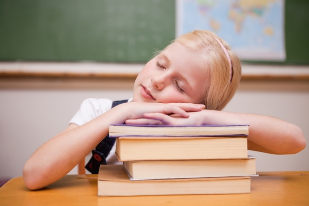 Girl sleeping on her books