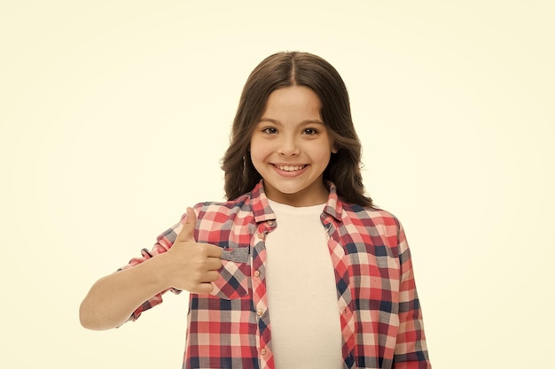 Girl smiling face feels confident Child confidently showing thumbs up Upbringing confidence concept Feel so confident with parental support I like it Kid girl long curly hair posing confidently