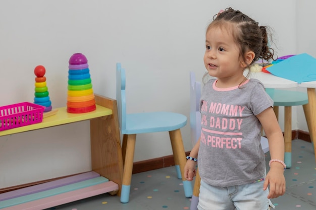 Girl smiling in play area of pediatric office