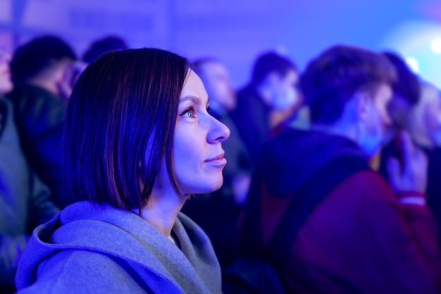 Girl standing at concert in neon light