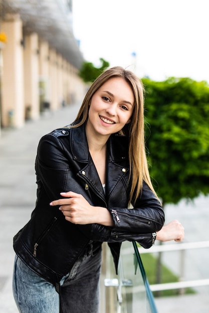 Girl standing on the stone stairs and handrail at the street