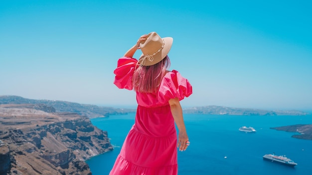 Girl standing in the top of the Santorini - Traveling in Santorini