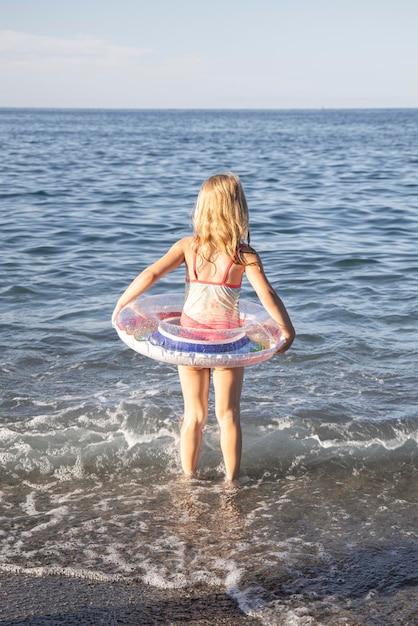 girl stands on the seashore and beach