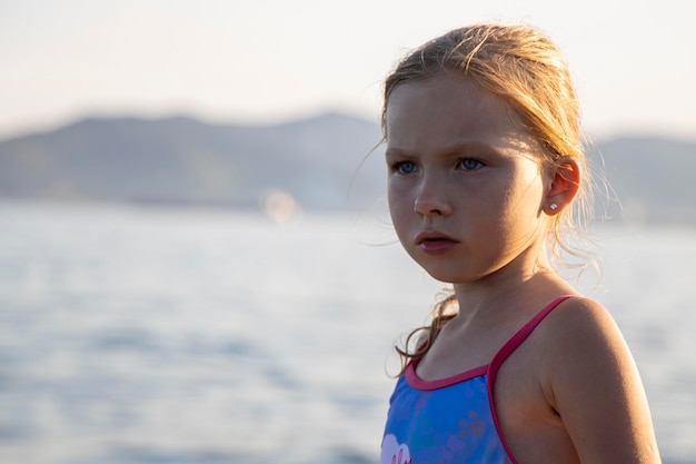 girl stands on the seashore and beach