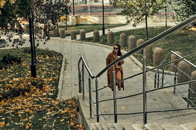 Girl on the street with a disposable paper cup. Take away food, walk around the city.