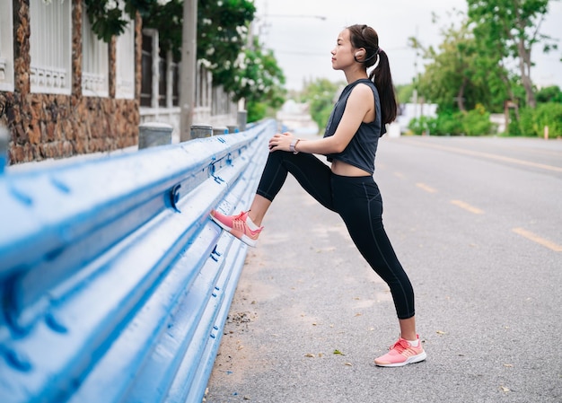 Girl stretching leg before jogging